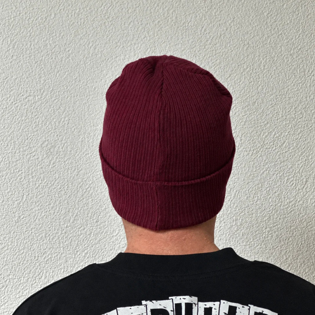 Unwritten beanie in burgundy worn by Benoît, founder of JaOcCo, back view