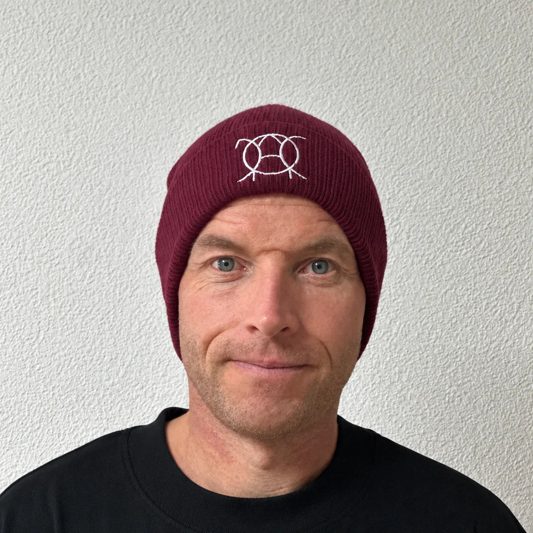 Unwritten beanie in burgundy worn by Benoît, founder of JaOcCo, front view