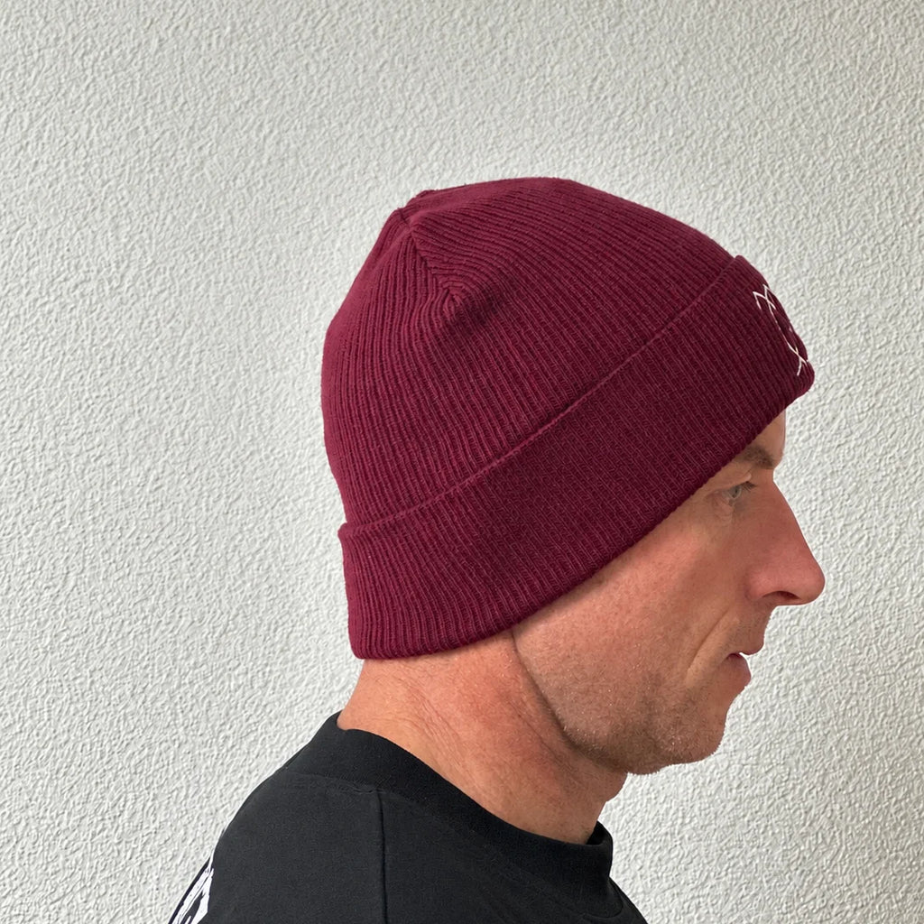 Unwritten beanie in burgundy worn by Benoît, founder of JaOcCo, three-quarter view
