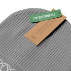 Light grey ribbed beanie with its organic cotton tag